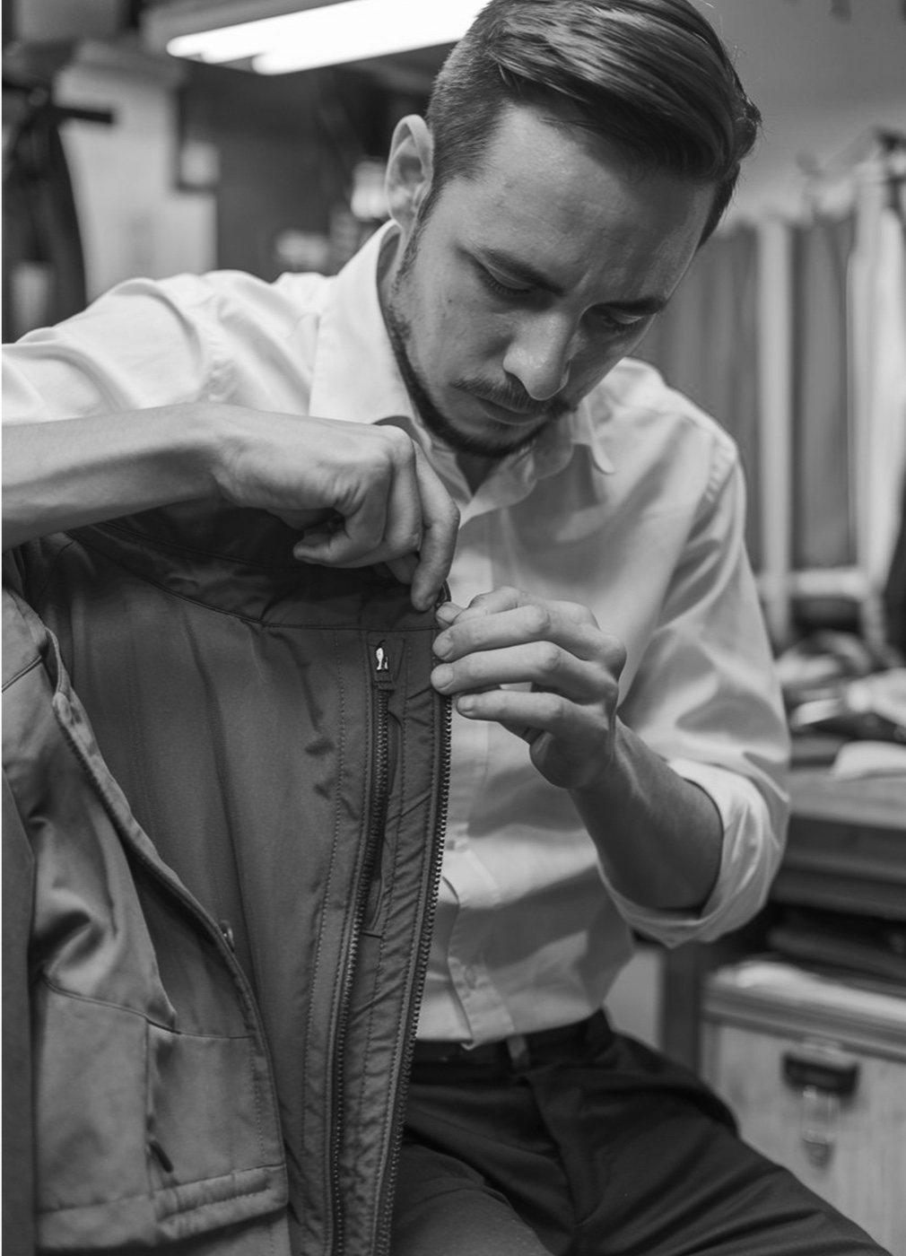 A tailor refitting the zipper on a jacket