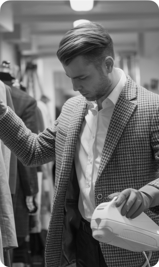 A man steaming a checked blazer